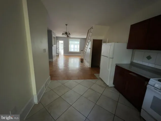 a view of a kitchen with a sink and a refrigerator