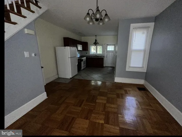 a view of a livingroom with a furniture wooden floor and window