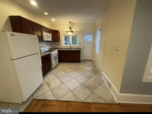 a kitchen with stainless steel appliances a refrigerator and a stove