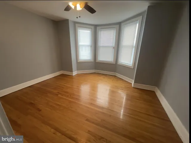 a view of an empty room with closet and a window