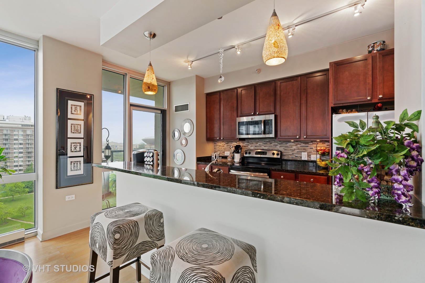 1629 South Prairie Avenue, Unit 1111 Chicago, IL 60616 - Photo 8 of 13 a kitchen with granite countertop a stove top oven a sink a dining table and chairs