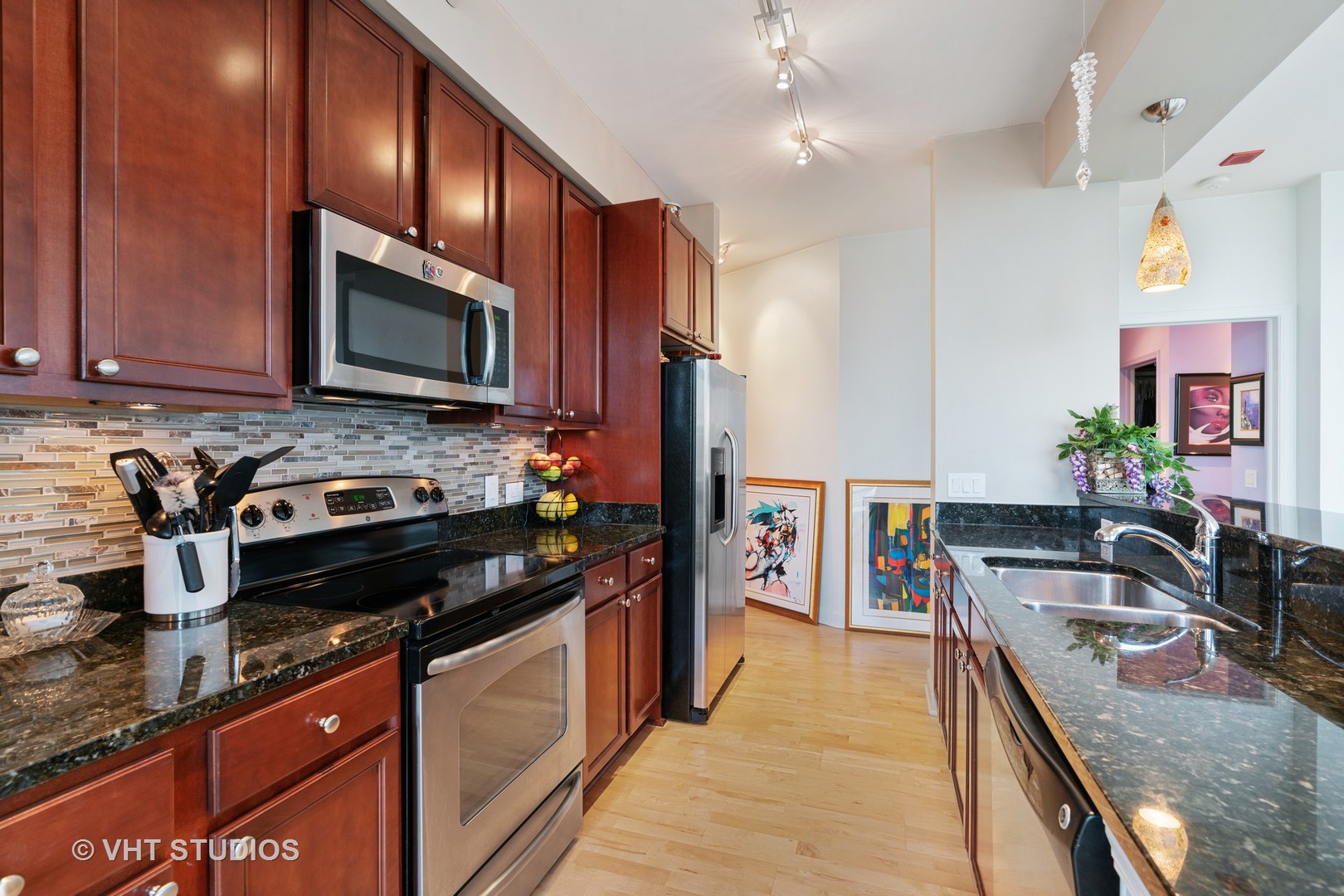 1629 South Prairie Avenue, Unit 1111 Chicago, IL 60616 - Photo 9 of 13 a kitchen with granite countertop a stove sink and microwave