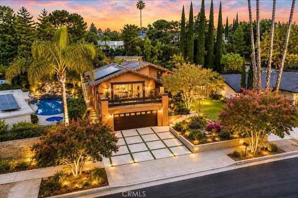 a front view of a house with a garden