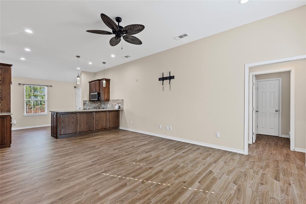 2910 Monroe Street Commerce, TX 75428 - Photo 11 of 34 a view of an empty room with a window and wooden floor