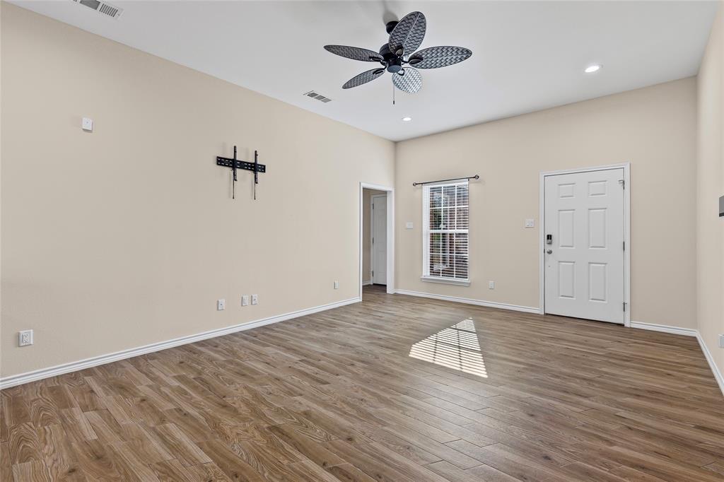 2910 Monroe Street Commerce, TX 75428 - Photo 12 of 34 a view of an empty room with a window and wooden floor