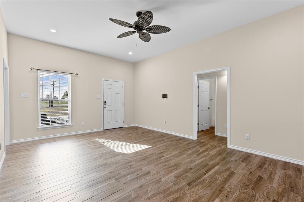 2910 Monroe Street Commerce, TX 75428 - Photo 13 of 34 a view of an empty room with a window and wooden floor