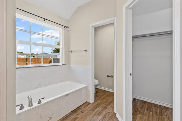 a bathroom with a bathtub and a shower