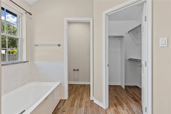 a bathroom with a tub shower and a sink