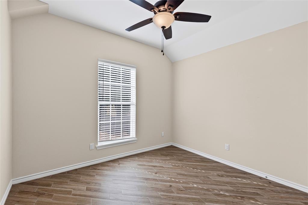 2910 Monroe Street Commerce, TX 75428 - Photo 20 of 34 a view of an empty room with wooden floor and a window