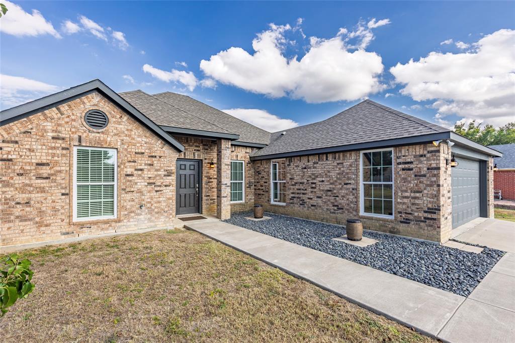 2910 Monroe Street Commerce, TX 75428 - Photo 2 of 34 a front view of a house with a large window and chandelier
