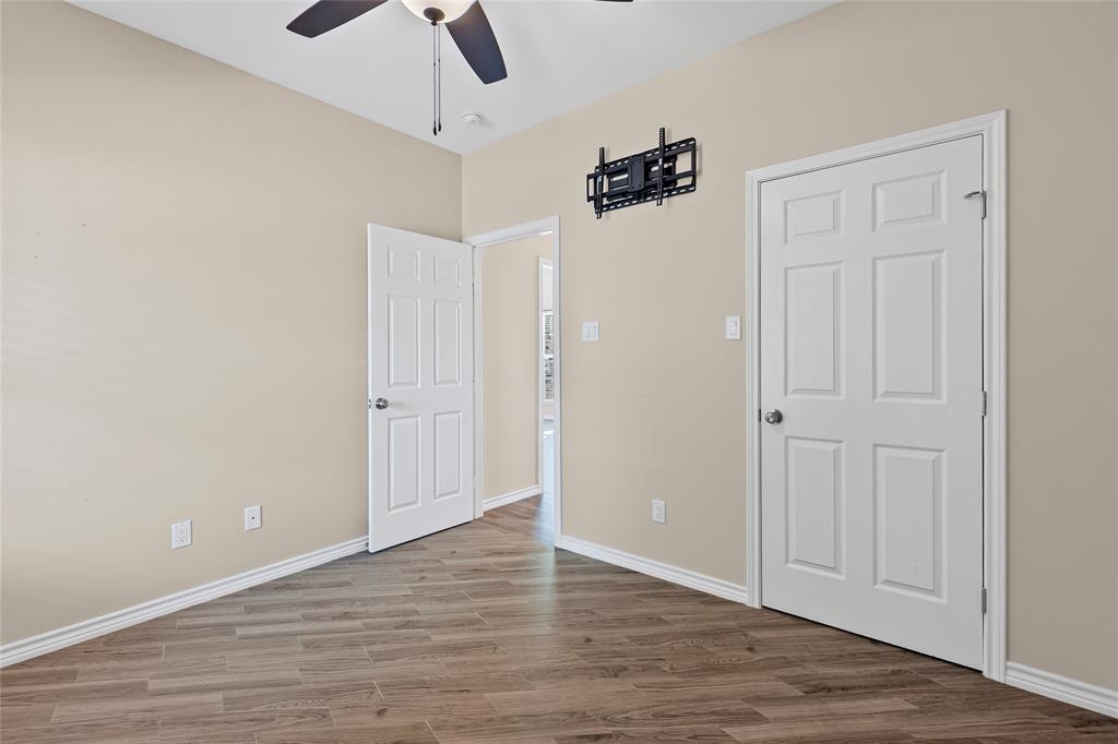 2910 Monroe Street Commerce, TX 75428 - Photo 23 of 34 wooden floor in an empty room