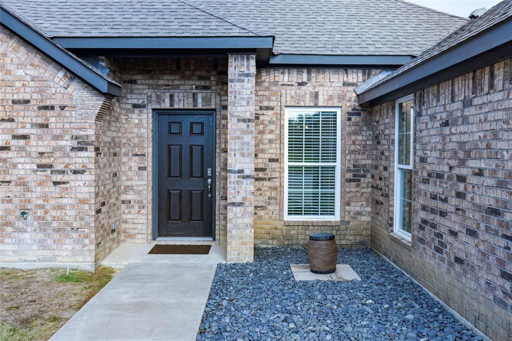 2910 Monroe Street Commerce, TX 75428 - Photo 3 of 34 a front view of a house with garden