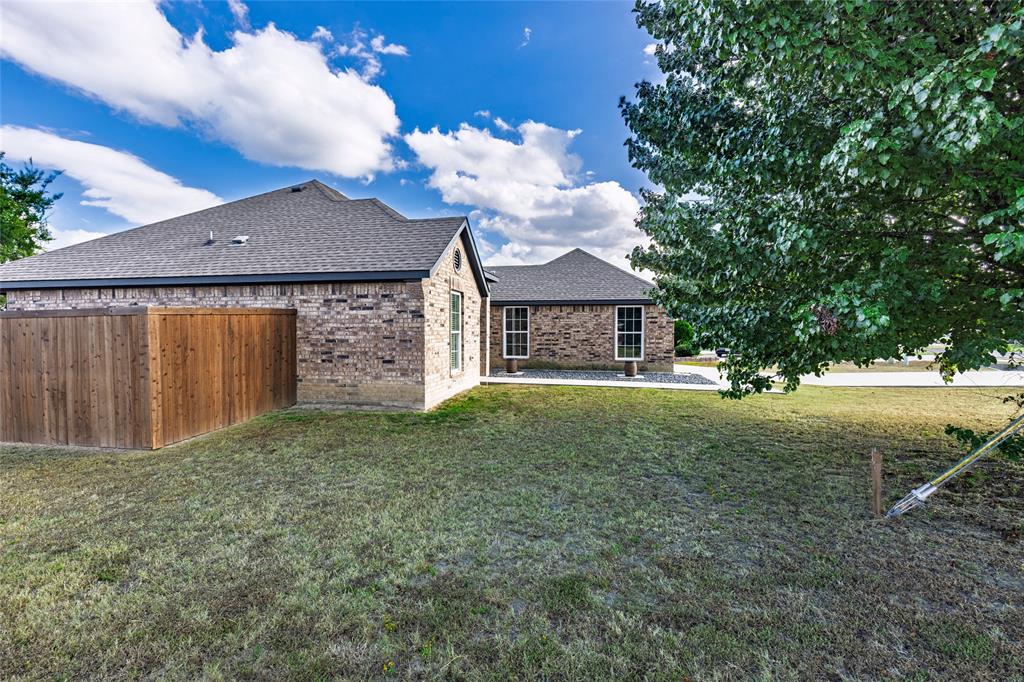 2910 Monroe Street Commerce, TX 75428 - Photo 32 of 34 a front view of a house with garden