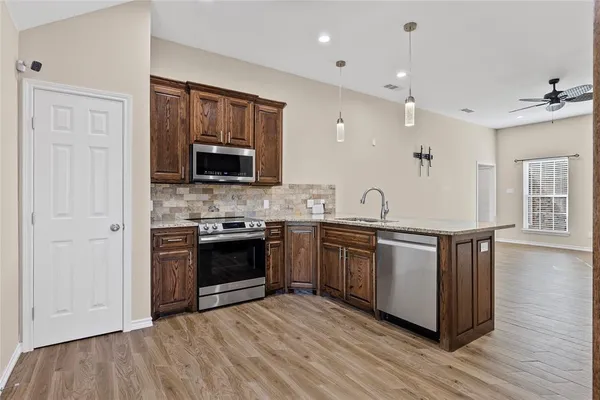 a kitchen with granite countertop a stove and a sink
