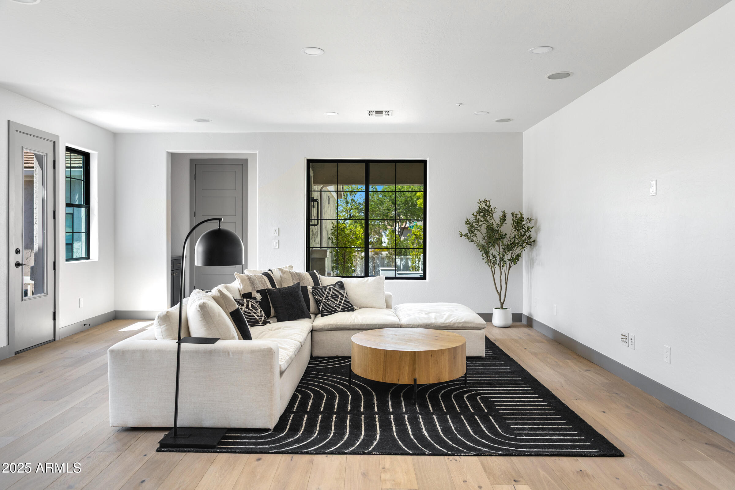 3102 East Agritopia Loop North Gilbert, AZ 85296 - Photo 12 of 75 a living room with furniture and a large window