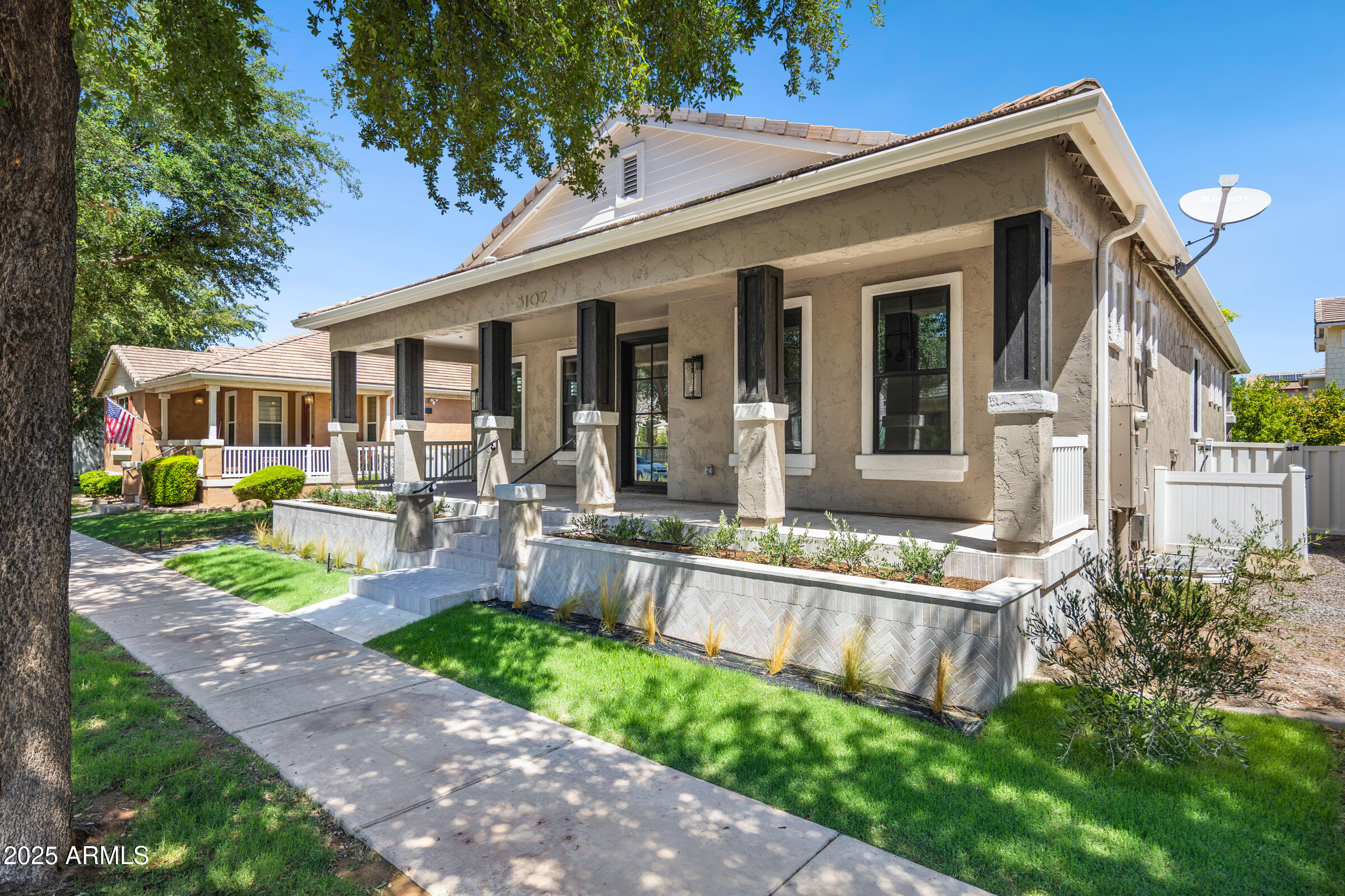 3102 East Agritopia Loop North Gilbert, AZ 85296 - Photo 5 of 75 a front view of a house with a yard table and chairs