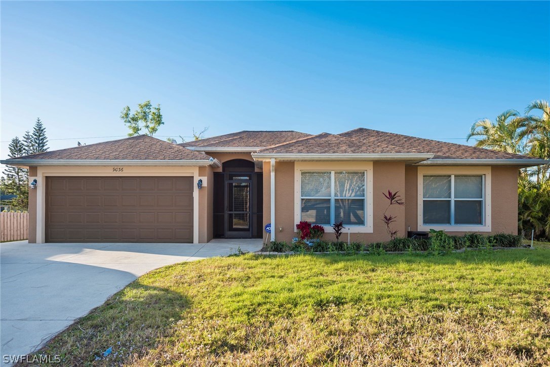 9036 Henry Road Fort Myers, FL 33967 - Photo 1 of 22 a front view of a house with a yard
