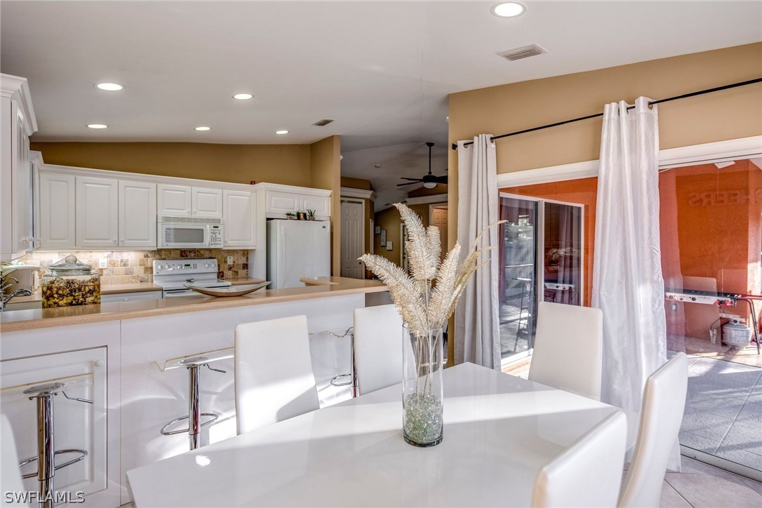 9036 Henry Road Fort Myers, FL 33967 - Photo 11 of 22 a kitchen with stainless steel appliances granite countertop a sink and a refrigerator