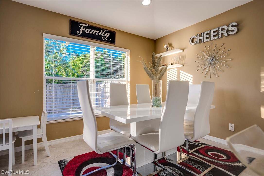 9036 Henry Road Fort Myers, FL 33967 - Photo 12 of 22 a view of a dining room with furniture window and outside view
