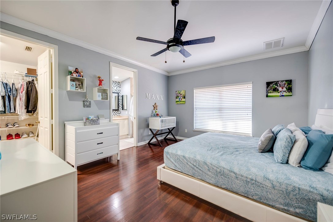 9036 Henry Road Fort Myers, FL 33967 - Photo 14 of 22 a bedroom with a bed and wooden floor