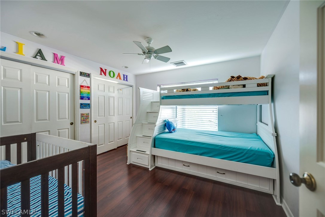 9036 Henry Road Fort Myers, FL 33967 - Photo 17 of 22 a bedroom with furniture and a book shelf