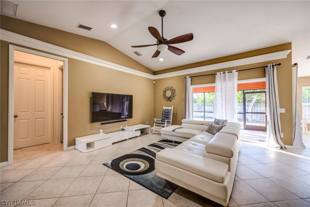 9036 Henry Road Fort Myers, FL 33967 - Photo 6 of 22 a living room with furniture a flat screen tv and a window