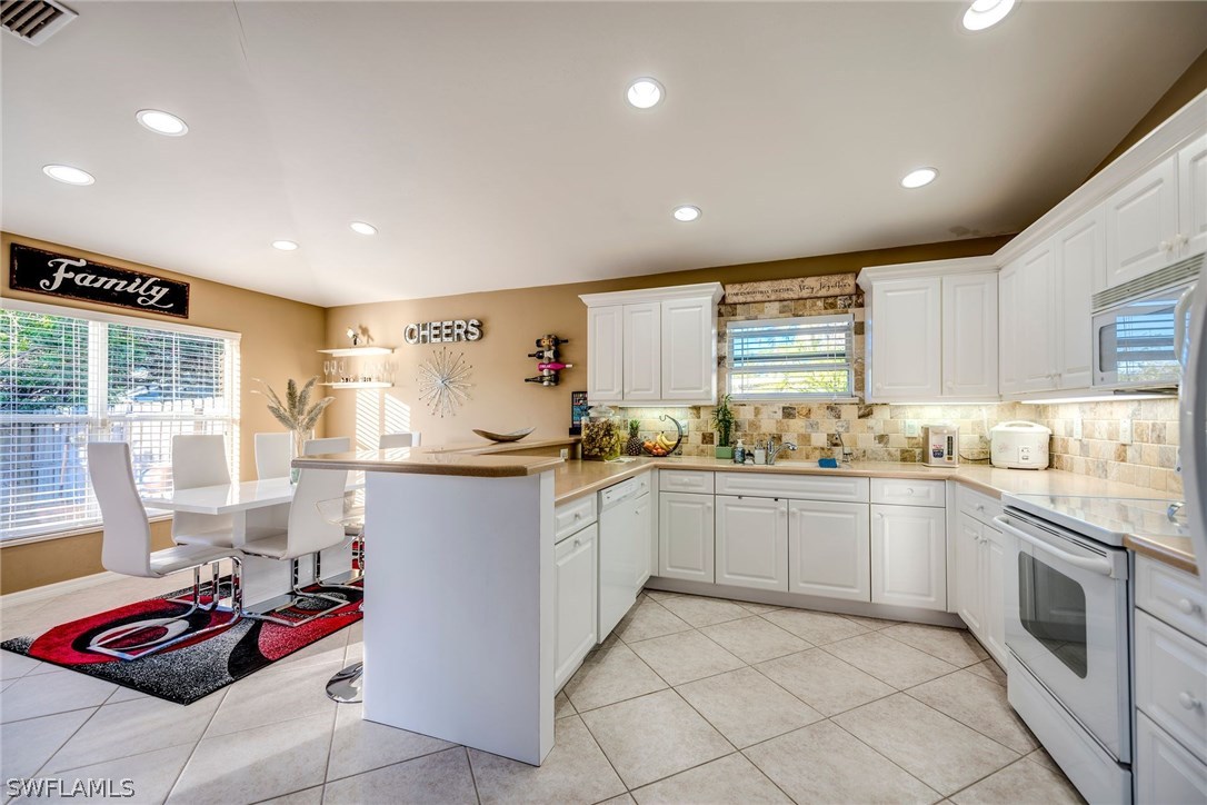 9036 Henry Road Fort Myers, FL 33967 - Photo 8 of 22 a kitchen with a sink window and cabinets