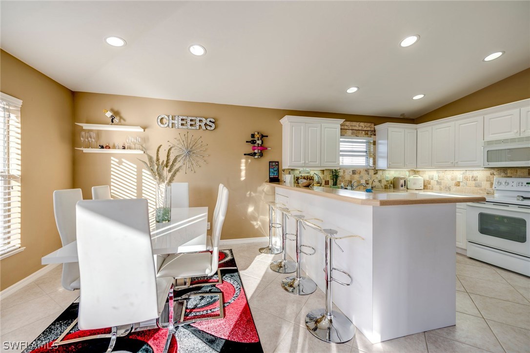 9036 Henry Road Fort Myers, FL 33967 - Photo 9 of 22 a kitchen with stainless steel appliances granite countertop a sink and cabinets