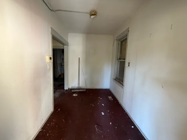 a view of an empty room and a window