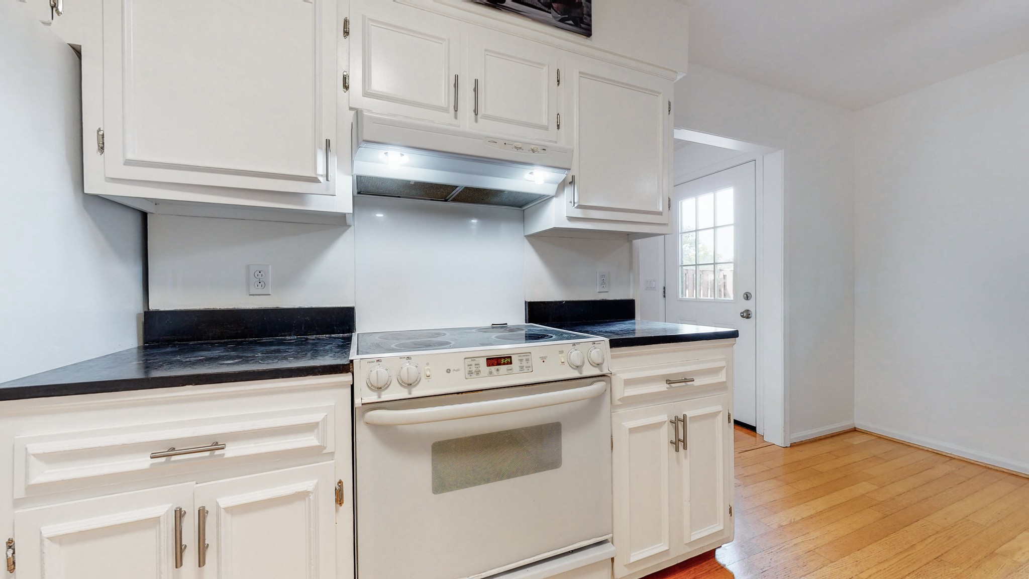 839 General George Patton Road Nashville, TN 37221 - Photo 12 of 59 a kitchen with granite countertop white cabinets and white appliances