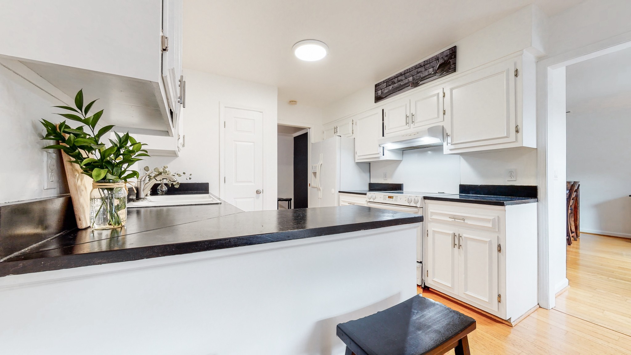 839 General George Patton Road Nashville, TN 37221 - Photo 15 of 59 a kitchen with stainless steel appliances granite countertop a refrigerator a stove a sink and white cabinets