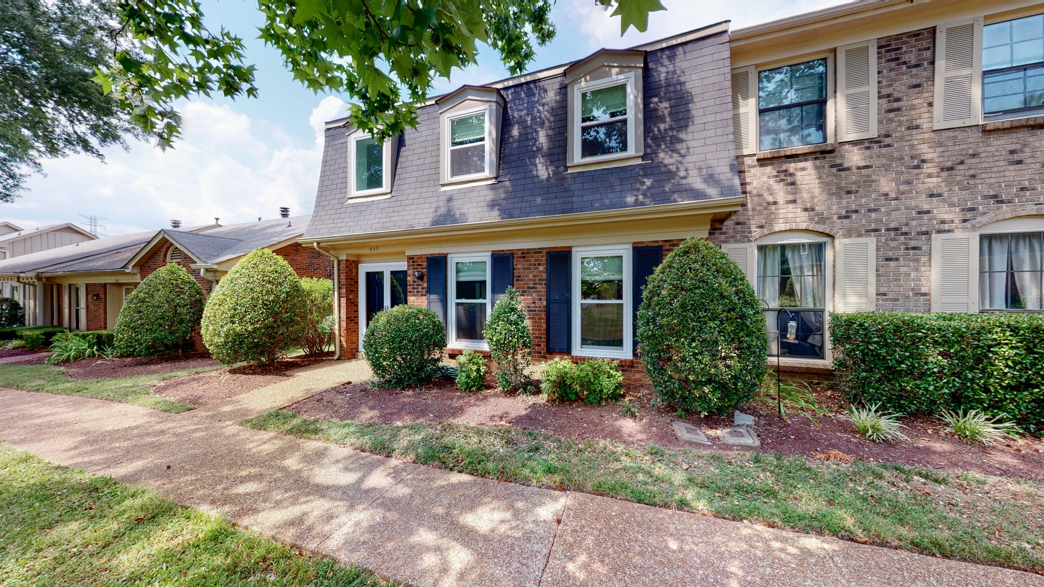 839 General George Patton Road Nashville, TN 37221 - Photo 39 of 59 a view of a brick house with many windows plants and large tree