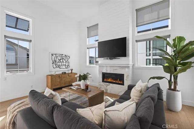 a living room with furniture a flat screen tv and a fireplace