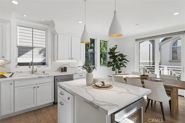 a kitchen with a sink stove and white cabinets