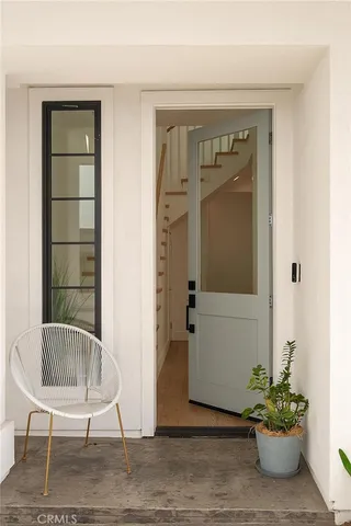 a view of entryway with stairs and wooden floor