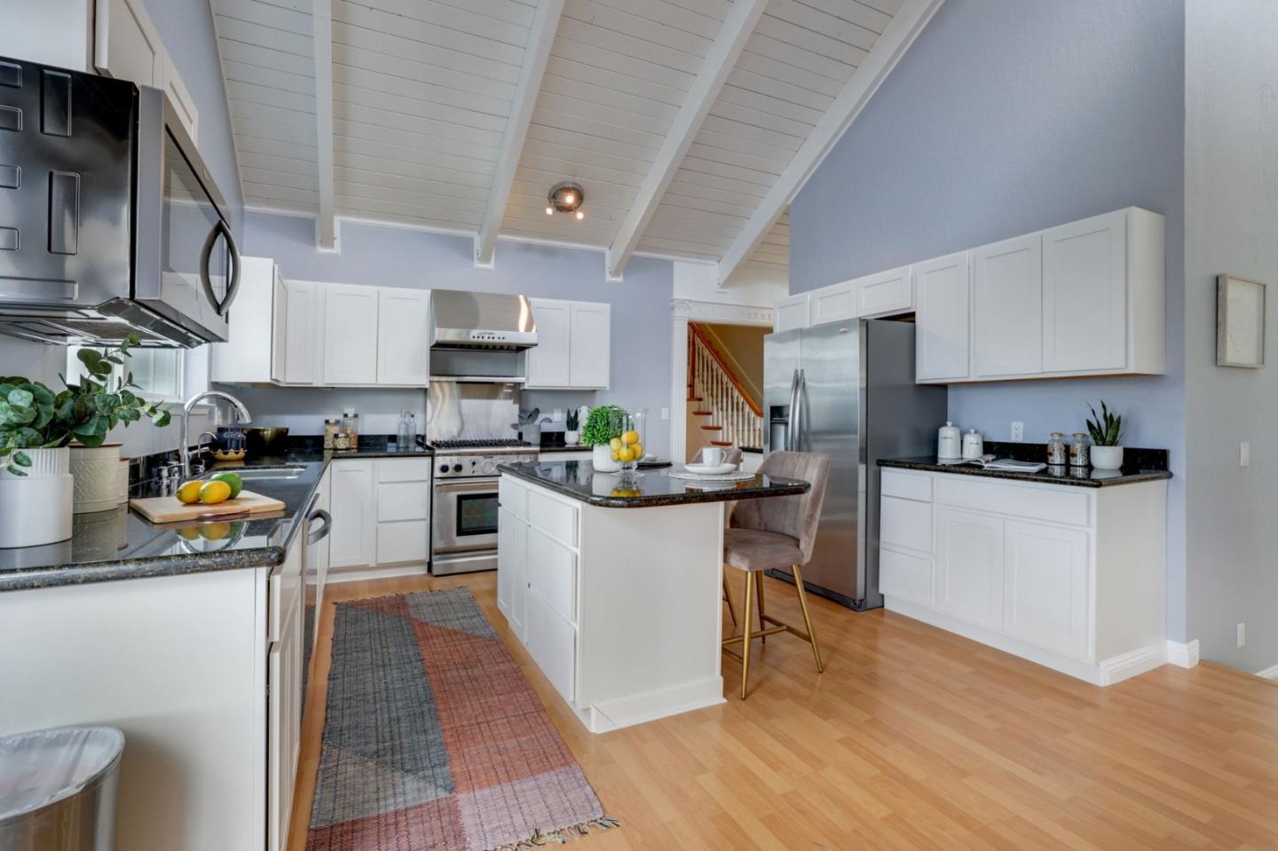 3303 Americus Drive San Jose, CA 95148 - Photo 12 of 51 a kitchen with stainless steel appliances granite countertop a refrigerator a stove a sink dishwasher and white cabinets with wooden floor