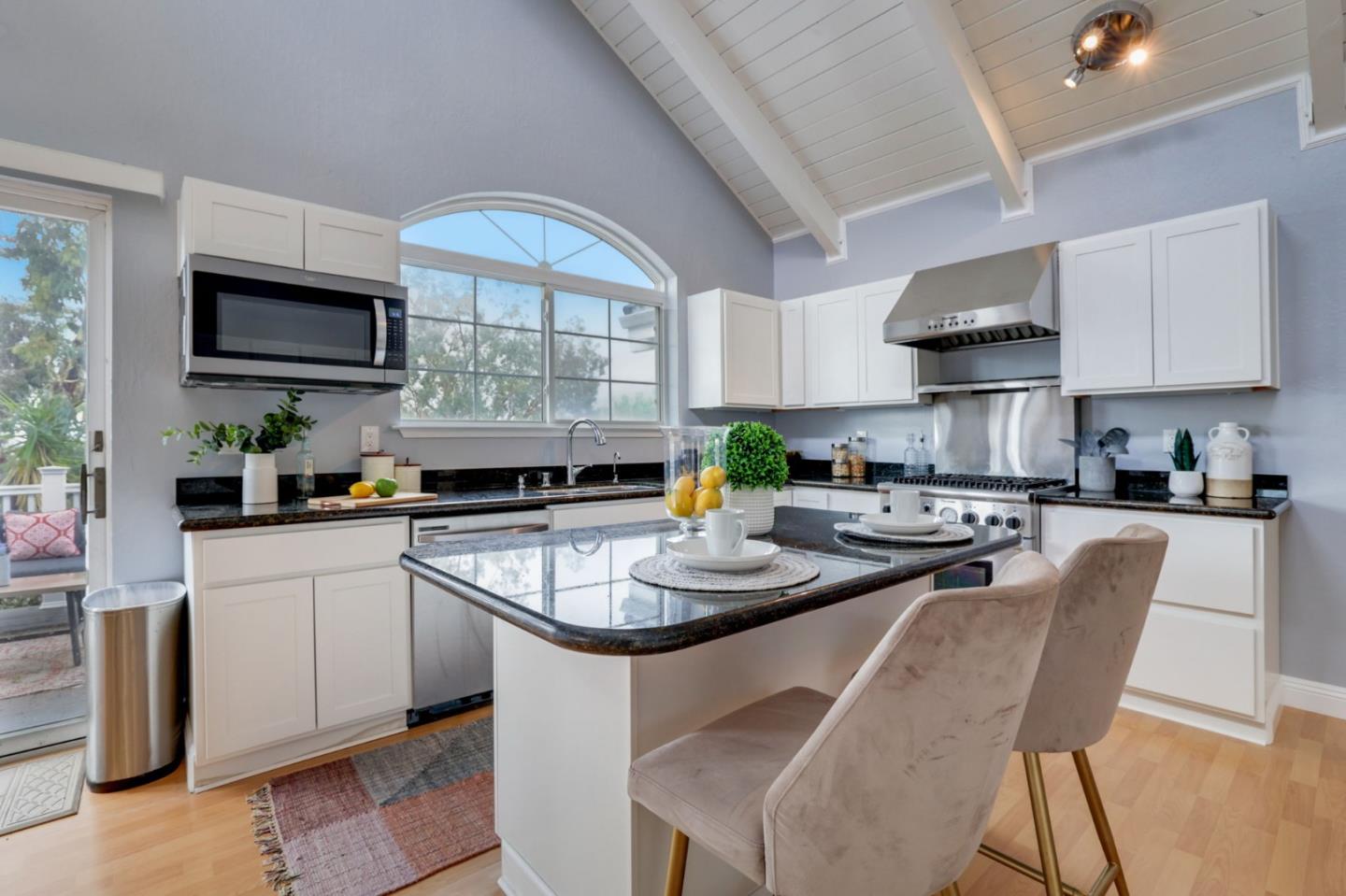 3303 Americus Drive San Jose, CA 95148 - Photo 13 of 51 a kitchen with stainless steel appliances granite countertop a stove a sink a microwave refrigerator and chairs