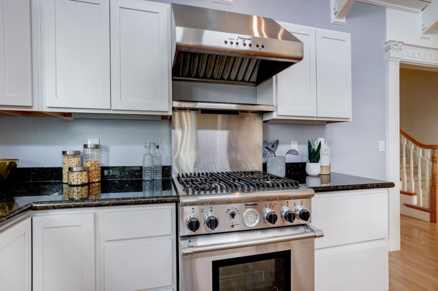 3303 Americus Drive San Jose, CA 95148 - Photo 16 of 51 a kitchen with granite countertop a stove and cabinets