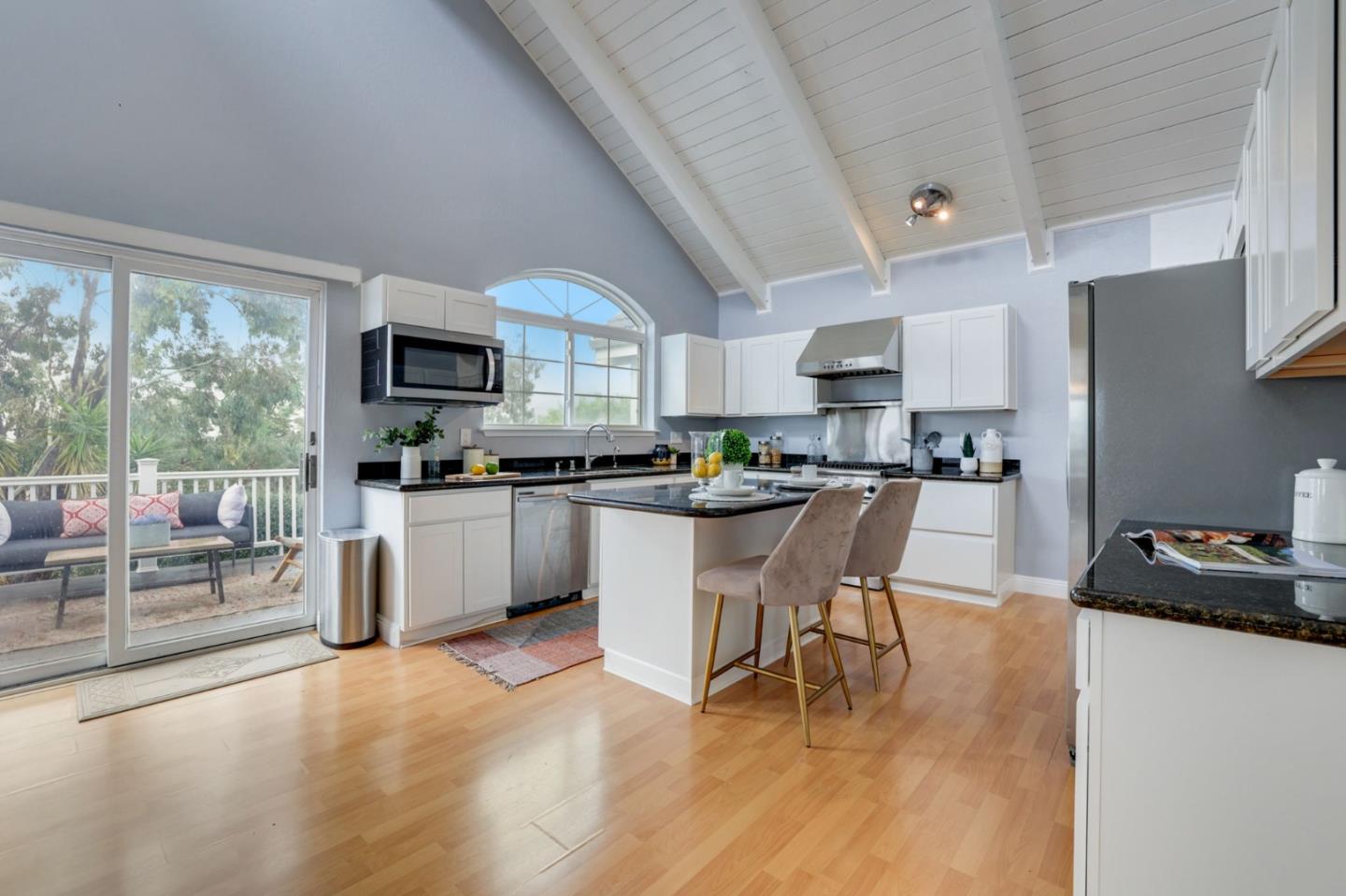 3303 Americus Drive San Jose, CA 95148 - Photo 10 of 51 a kitchen with white cabinets and black stainless steel appliances