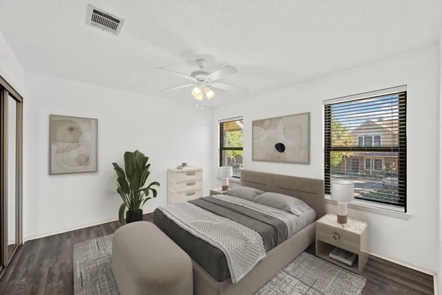 a bedroom with a large bed and a window