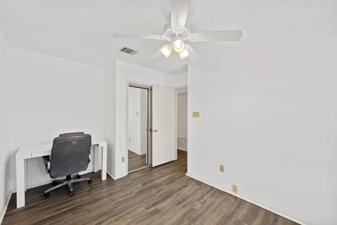 a view of a workspace with furniture and wooden floor