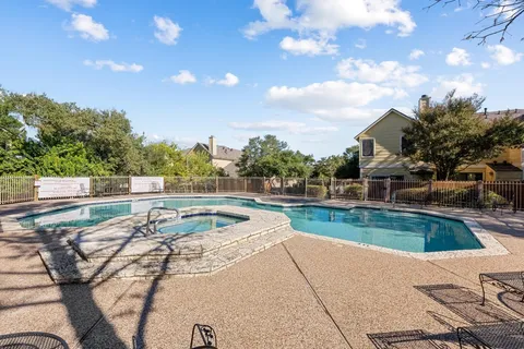 a view of a swimming pool with a patio and a yard