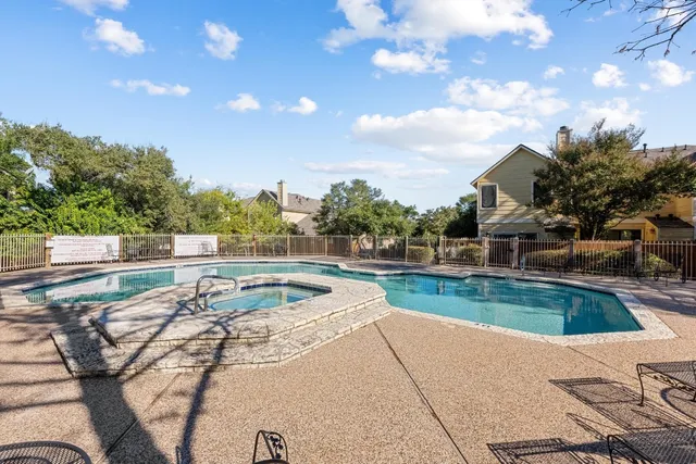 a view of a swimming pool with a patio and a yard