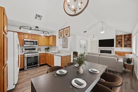 a kitchen with stainless steel appliances granite countertop a stove and a refrigerator