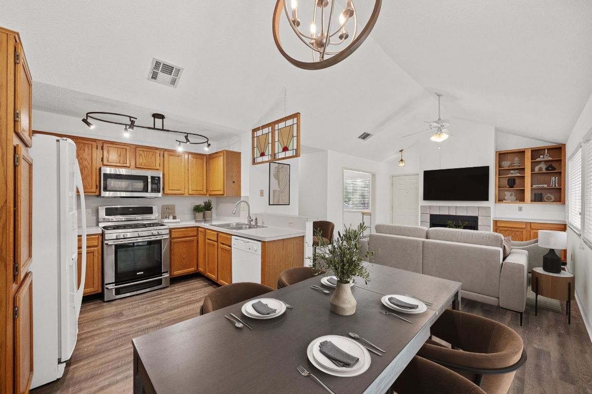 11901 Swearingen Drive, Unit 39 Austin, TX 78758 - Photo 6 of 25 a kitchen with stainless steel appliances granite countertop a stove and a refrigerator