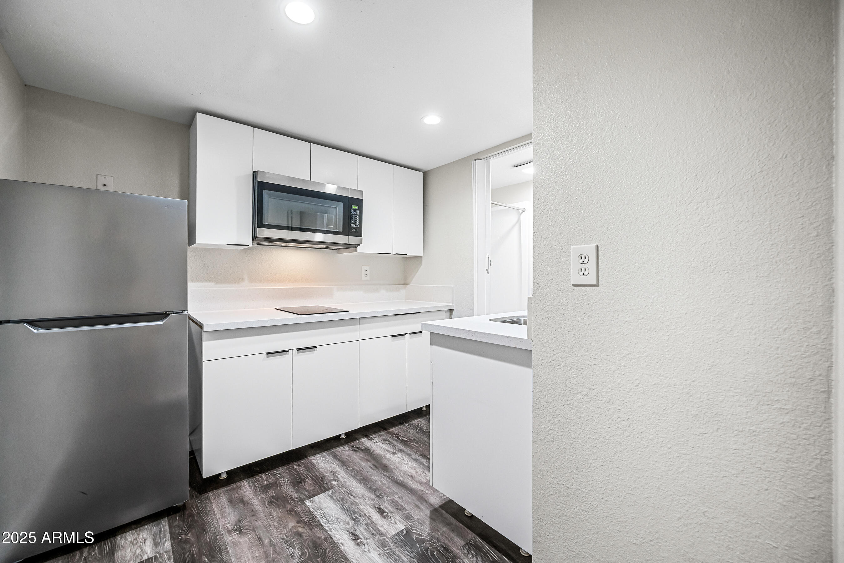 3025 North 32nd Street, Unit 10 Phoenix, AZ 85018 - Photo 6 of 21 a kitchen with stainless steel appliances a refrigerator and a microwave