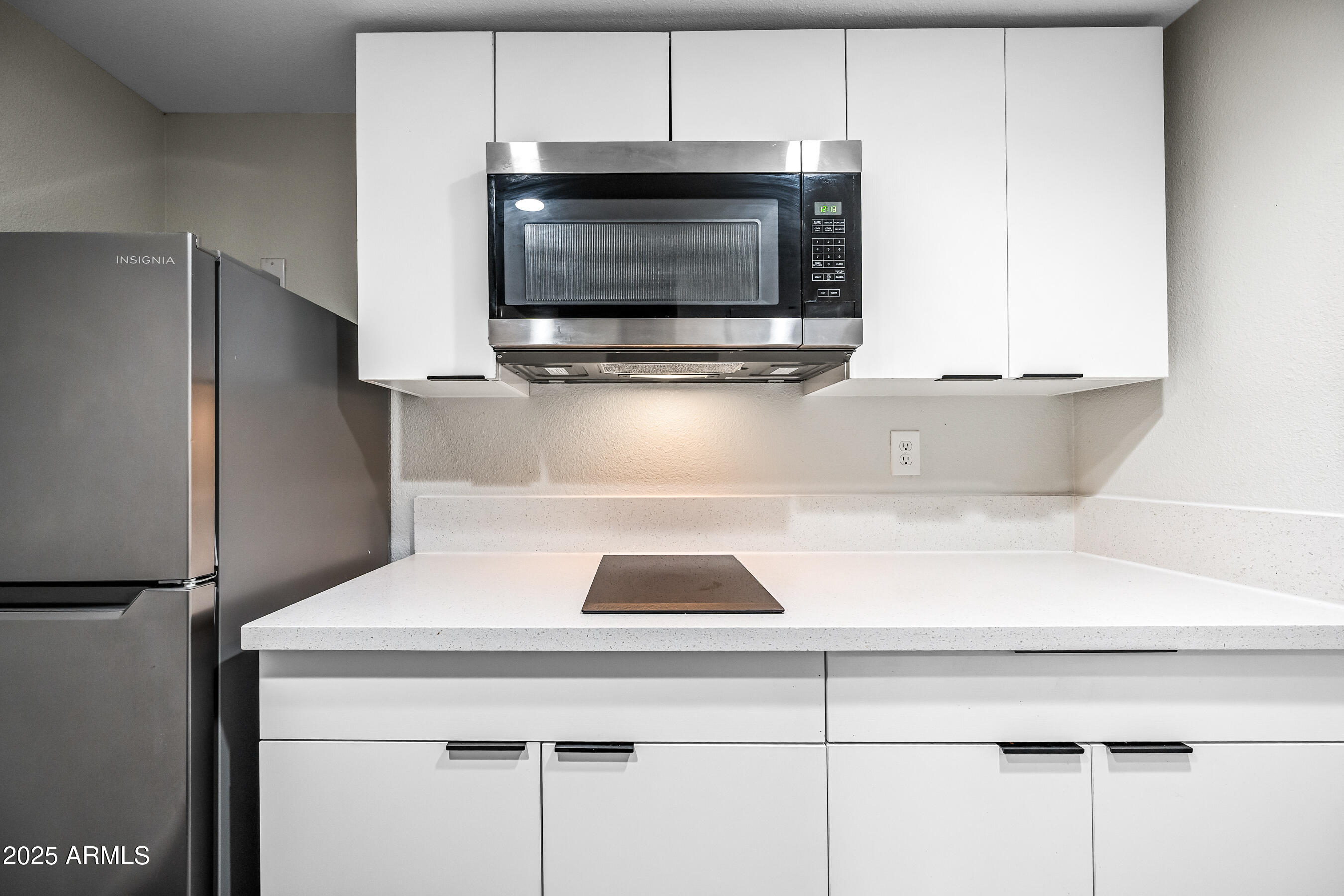 3025 North 32nd Street, Unit 10 Phoenix, AZ 85018 - Photo 8 of 21 a kitchen with a microwave and a refrigerator
