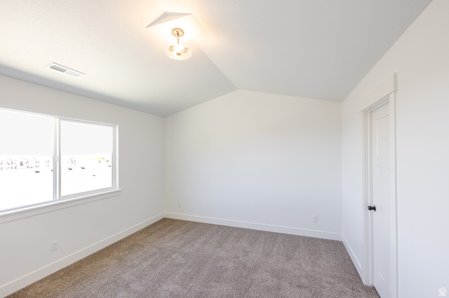 4752 Heartwood Road, Unit 433 Mapleton, UT 84664 - Photo 14 of 20 Spare room featuring light carpet and vaulted ceiling