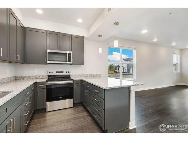 a kitchen with kitchen island a sink stainless steel appliances and cabinets