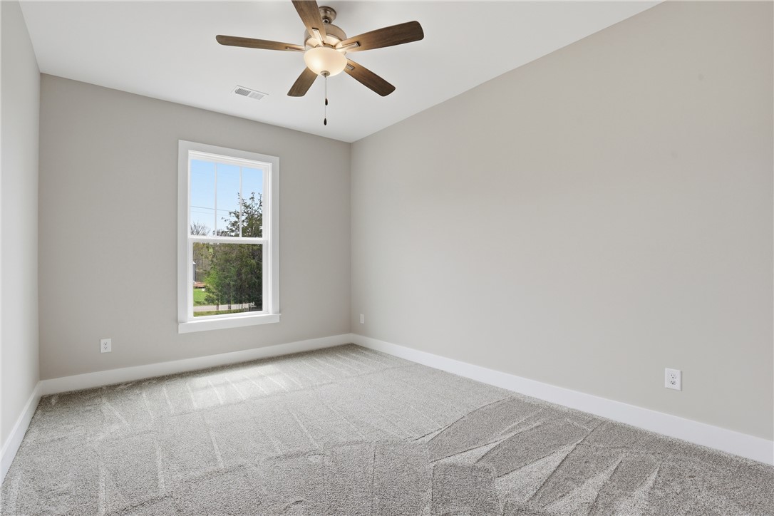 736 Stewart Gin Road Liberty, SC 29657 - Photo 34 of 50 This airy room offers a tranquil escape, featuring soft carpeting and a window overlooking lush greenery.